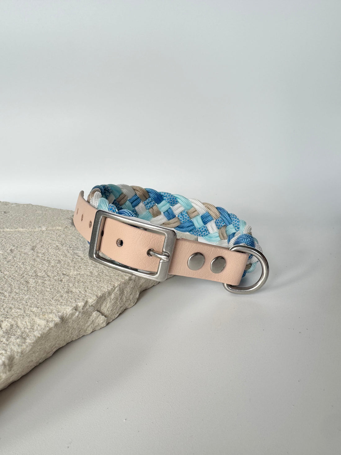 Dog collar with blue and beige pattern on a light gray background