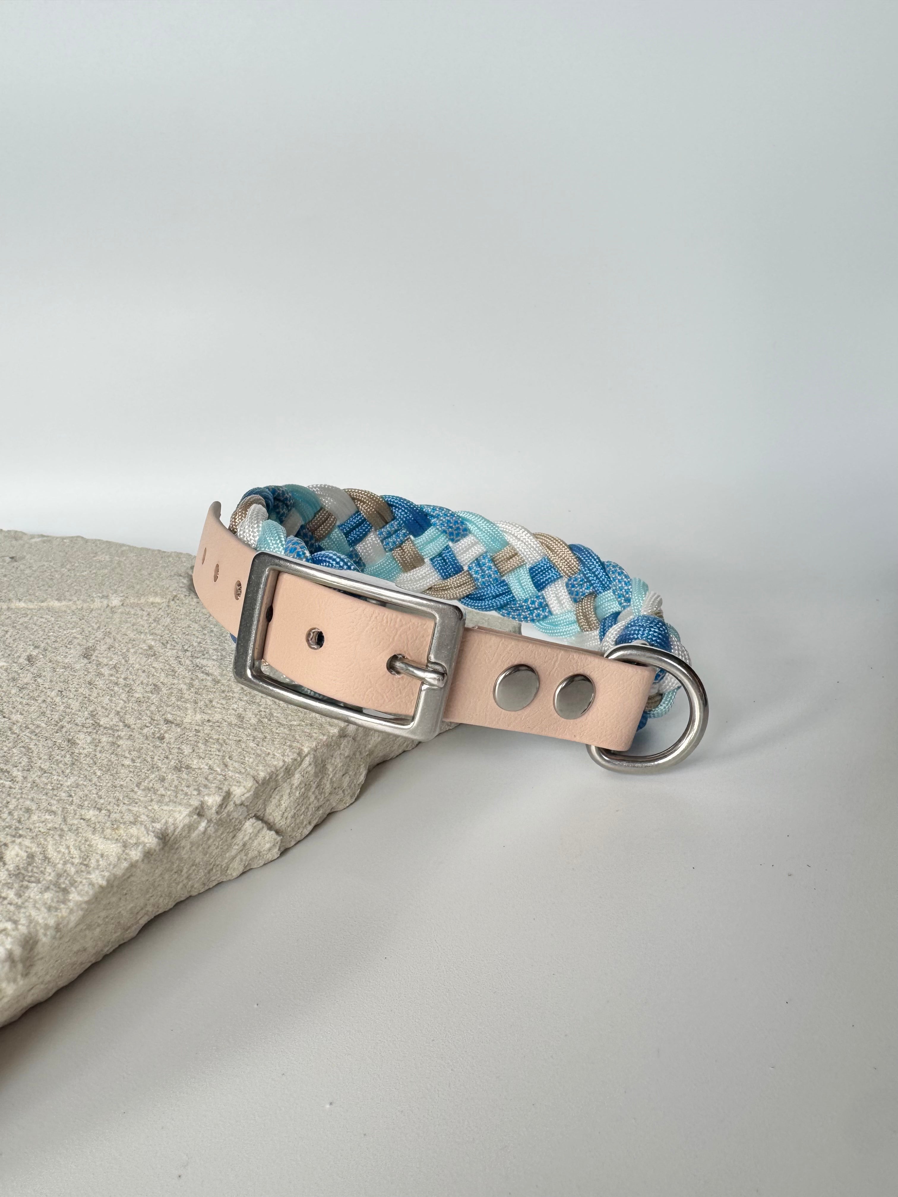 Dog collar with blue and beige pattern on a light gray background